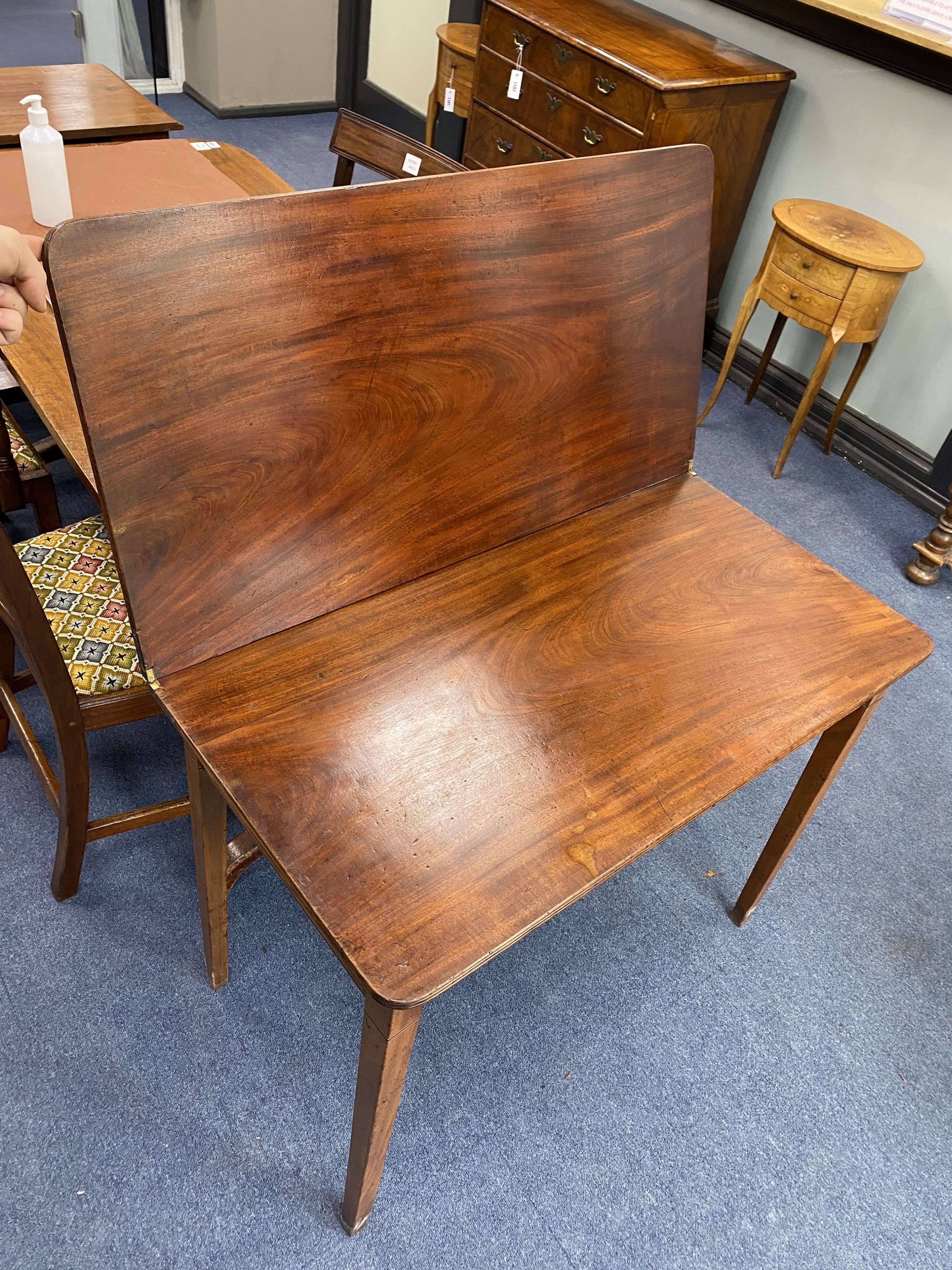A George III mahogany folding tea table, width 88cm, depth 45cm, height 71cm